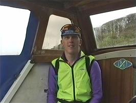 Julian takes one of the few remaining seats on the private boat as we cross Loch Broom from the Alltnaharrie Inn to Ullapool